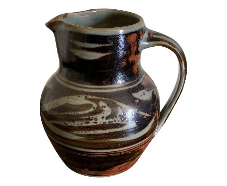 A Crowan Pottery jug with green, black and terracotta glaze, height 18cm.From the estate of Ashley Barker OBE who was born in