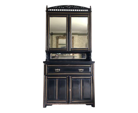 An Aesthetic Movement secretaire bookcase with gilt mouldings, the arched cornice with spindles and gilt carved foliage in lo