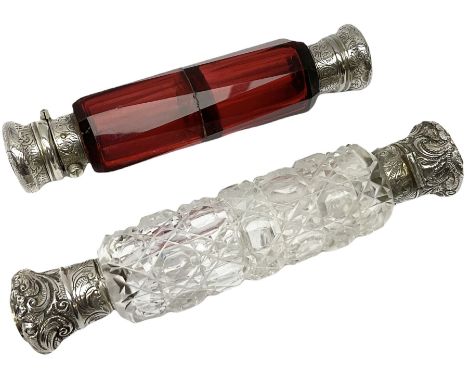 Two Victorian white metal mounted double ended scent bottles, comprising a ruby glass example with scroll engraved covers, L1