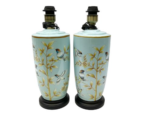 Pair of ceramic table lights, depicting birds and floral spay on a light blue ground, on a wooden plinth, H43cm. 