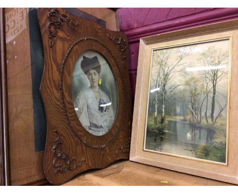 Portrait of a lady in decorated wooden frame and family photograph, plus river scenes and other prints