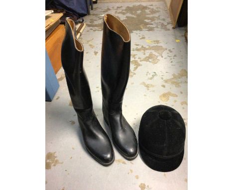 A riding hat, leather riding boots and three fur jackets