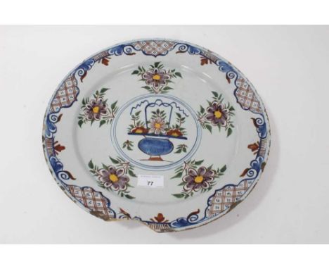 18th century Dutch Delft polychrome charger, decorated with flowers in a basket and further floral patterns, 35cm diameterCon