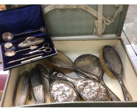Silver backed dressing table items, manicure set in fitted case and two spoons, all within vintage suitcase