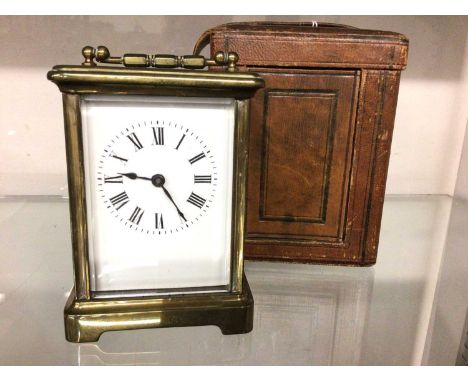 Brass carriage clock in leather travelling case