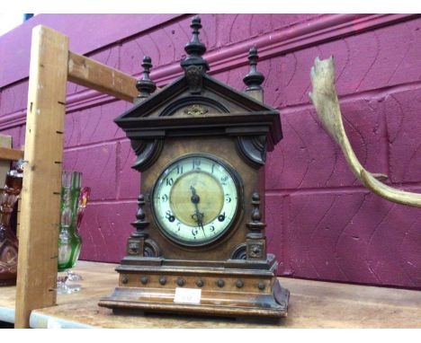 Mantel clock with turned finials, part enamelled dial and pendulum movement