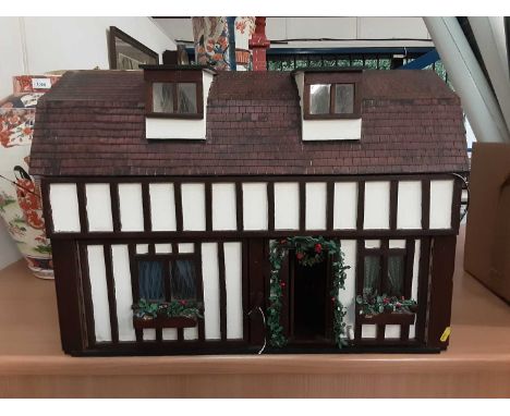 Good quality dolls house by G Ponnock. with electric light fitting and fitted with furniture