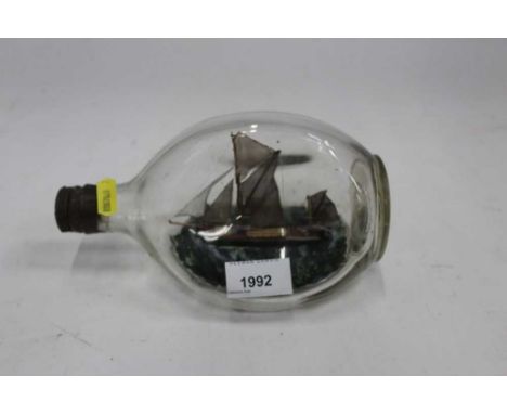 Vintage Ship in a bottle, the bottle measuring 21cm length