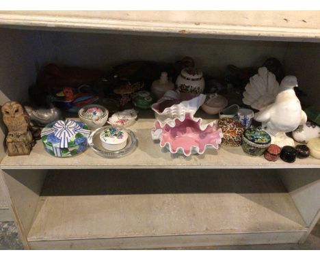 A shelf of duck figurines, boxes and other ornaments