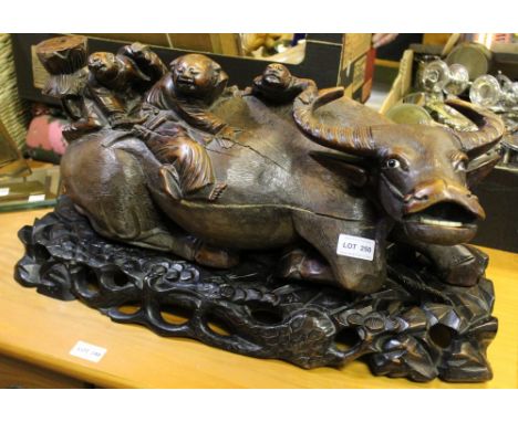 Early 20th century Japanese wood carving of boys atop a water buffalo 56cm long supported on a carved wood stand ( once used 