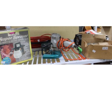 A shelf of mixed tools to include power sander, battery charger, cable storage, etc