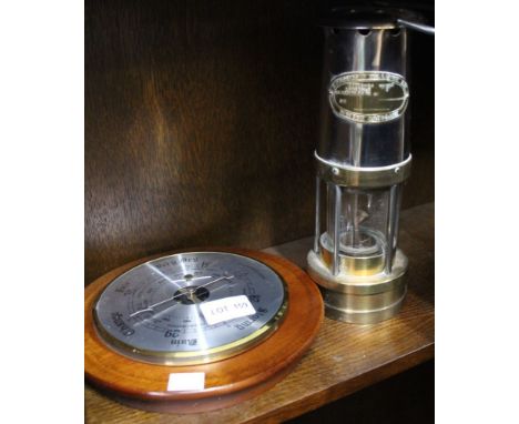An E Thomas &amp; Williams Ltd miners lamp together with a circular barometer