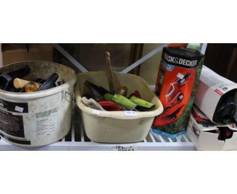 A shelf full of tools to include Dirt Devil, Black &amp; Decker cutter, various tools