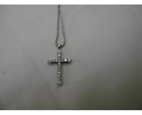 AN 18CT GOLD AND DIAMOND CROSS ON CHAIN