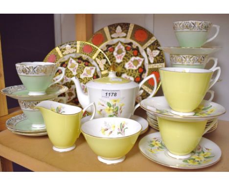 A Royal Albert tea-for-two, decorated with sprigs of primroses, yellow lustre glaze comprising tea pot, two cups and saucers,