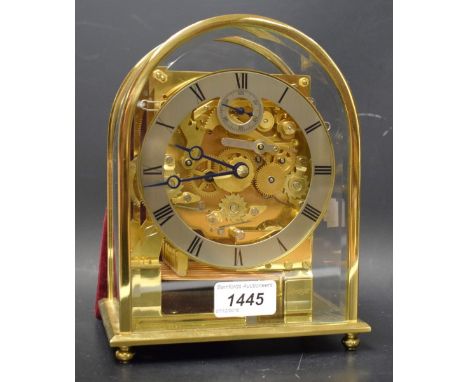 A Kieninger mantel clock, polished brass domed case with bevelled crystal glass