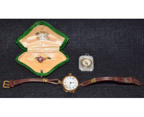 A lady's 9k gold watch, leather strap; a silver miniature compass; an 18ct gold diamond and ruby flowerhead ring, cased (3)