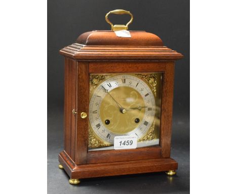 A Comitti of London basket top mahogany mantel clock