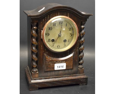 An oak cased striking mantel clock, c.1900, barley twist columns 