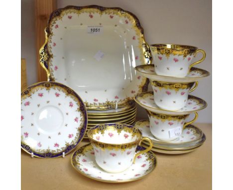 A Paragon China part tea service, gilded dark blue banding, pink roses, including eight side plates, four cups, six saucers, 