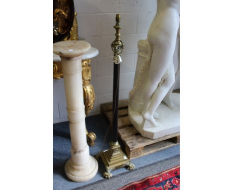 A brass Corinthian column style floor standing telescopic lamp.