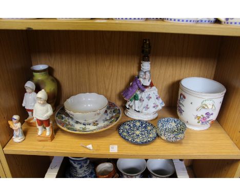 A shelf of decorative china.