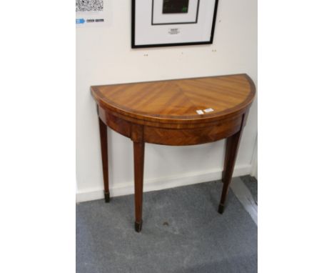 A good satinwood demi-lune foldover card table.