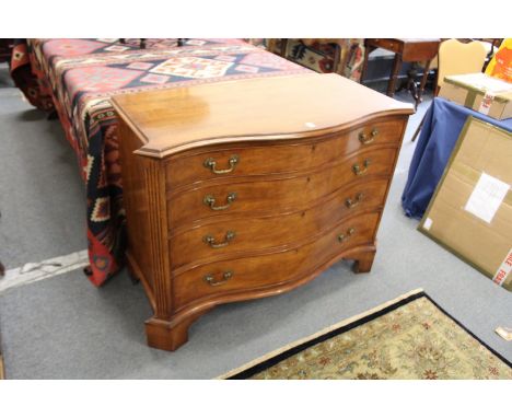 A good George III style mahogany serpentine fronted four drawer commode.