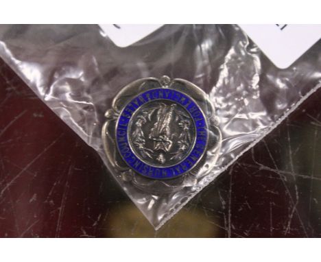 A silver and enamel General Nursing Council brooch.