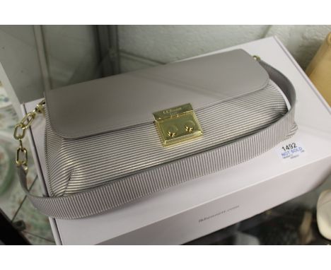 L. K. Bennett, a grey leather handbag with original box and dust cover.