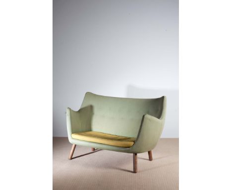 THE POET SOFA, BY FINN JUHL (1911-1989), DANISH, c.1950, the shaped body  retaining its original upholstery, on tapering spla