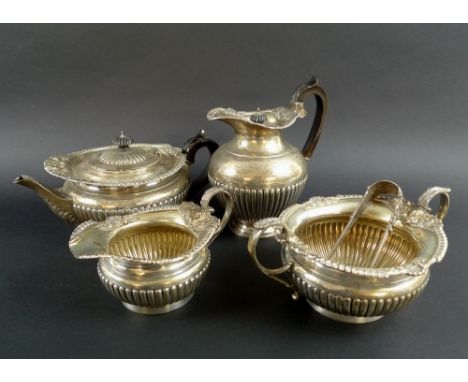 A Victorian five piece silver tea set, comprising tea pot, hot water pot, milk jug and sucrier, the rims elaborately cast wit