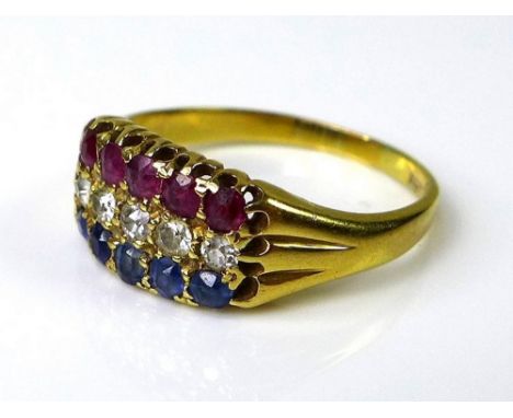 An early 20th century 18ct gold, diamond, ruby and sapphire triple row ring, the band of five old brilliant cut diamonds bord