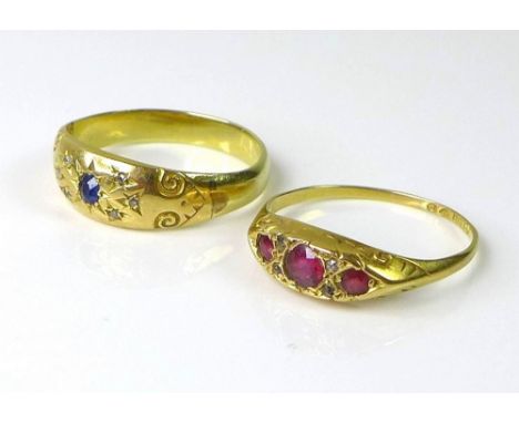 Two 18ct gold rings, one set with three rubies, interspersed with diamond chips, the other set with a single sapphire in a st