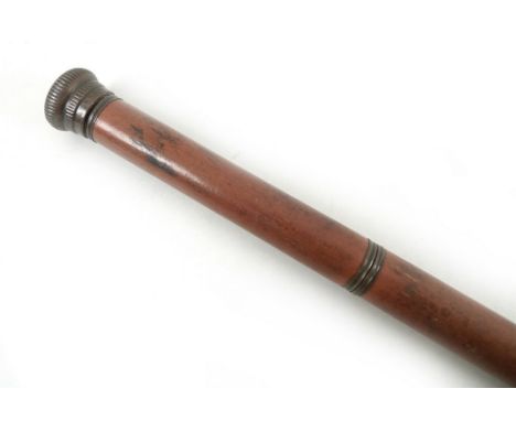 A mid 20th century wooden flask cane, containing a 39cm liquor vial in the lower portion of the cane, and a 5.7cm footed glas