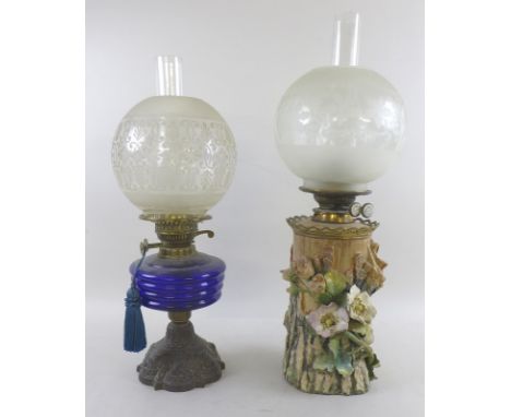 Two Duplex oil lamps, the first with blue ribbed glass reservoir and stepped foliate cast iron pedestal foot,  28cm (without 