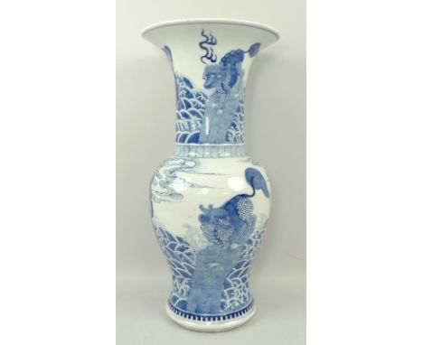 A Chinese porcelain vase, Kangxi style, probably 19th century, decorated in underglaze blue with mythical beasts perched on r