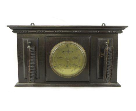 An Edwardian barometer, by Aitchison, London &amp; Provinces, with brass dial in a wall hanging ebonised oak case, with a pai