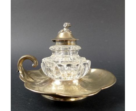 A Victorian silver and cut glass inkwell and stand, the stand resembling a lily-pad with six lobes and curling leaf handle, d