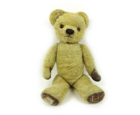 A mid 20th century Chad Valley mohair teddy bear, with jointed limbs and amber glass eyes, with label to paw inscribed 'By ap