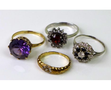 A collection of four rings, comprising a 9ct gold ring set with an amethyst, size O, 3.6g, a yellow metal ring with rope twis