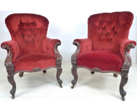 A pair of Victorian mahogany spoon back armchairs, matching lady's and gentleman's, with carved scroll and acanthus decoratio