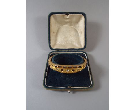 A 15ct Gold Bangle with Ruby and Diamond Insets. 14.7gms.