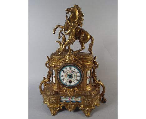 A Sevres Style Gilt Metal and Porcelain Panel Mantel Clock with Marley Horse Finial. 40.5cm high