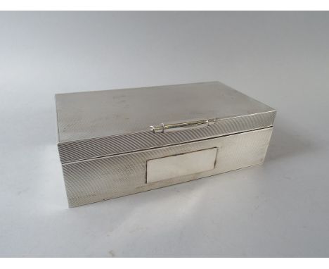 A Rectangular Silver Cigarette Box with Engine Turned Decoration. Birmingham 1962. 16.5x8.5x5cm High