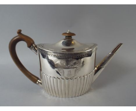 A Georgian Silver Teapot with Engraved Armorial Decoration and Ribbed Body. Wooden Handle and Finial. London 1793. 15.5cm Hig