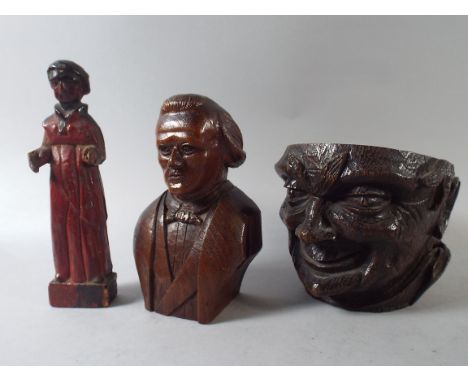 An Early Carved Wooden Painted Figure, a 19th Century Portrait Figure and a 19th Century Tobacco Pot Base in the Form of a Ge
