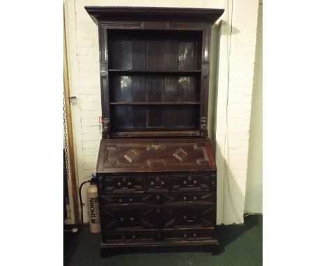 An Early Oak Bureau Bookcase. The Fielded Panelled Fall Front to Fitted Interior with Cupboard, Small Drawers and Pigeon Hole