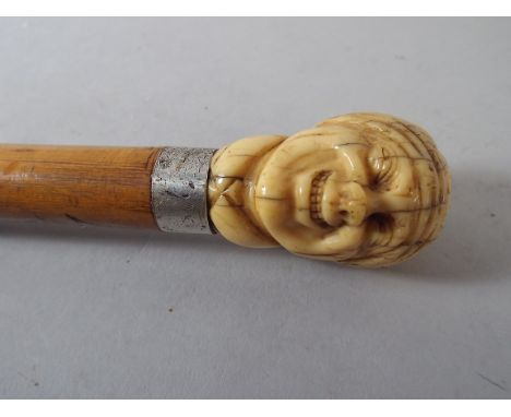 A Late 19th Century Walking Cane with Carved Finial of Gent with a Broad Grin. 80.5cm Long.