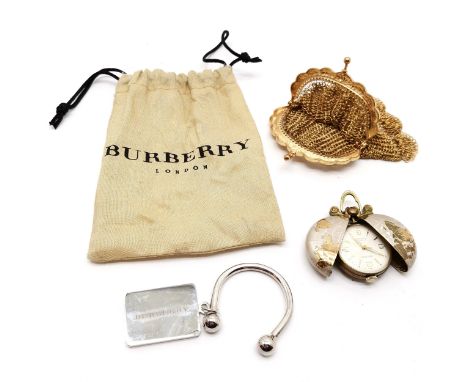 Burberry steel keys fob (in original bag), gilt metal coin purse (10cm x 6cm) &amp; unusual Estyma pendant mechanical wind wa